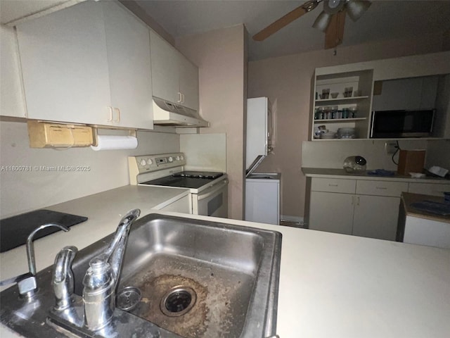 kitchen with white range with electric cooktop, under cabinet range hood, a ceiling fan, a sink, and light countertops
