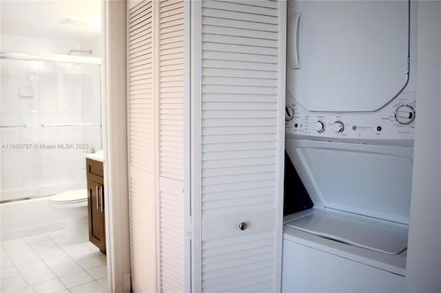 3300 NE 192nd St Unit 611, Aventura, FL 33180 - clothes washing area featuring stacked washer / drying machine and light tile patterned floors
