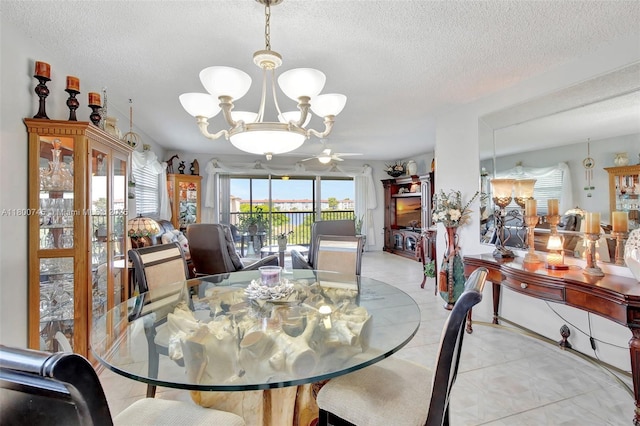 dining room featuring a chandelier, light tile patterned floors, and a textured ceiling