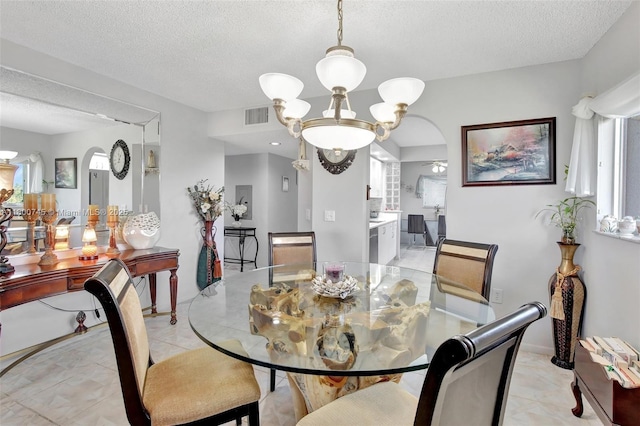 1500 SW 131st Way Unit 401N, Pembroke Pines, FL 33027 - dining room with plenty of natural light, a textured ceiling, a chandelier, and arched walkways