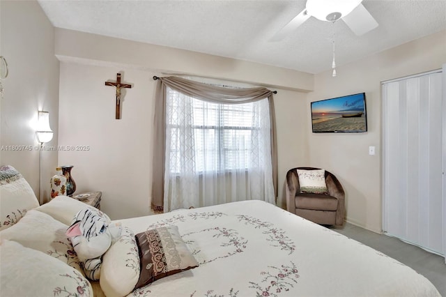 carpeted bedroom featuring ceiling fan and a closet