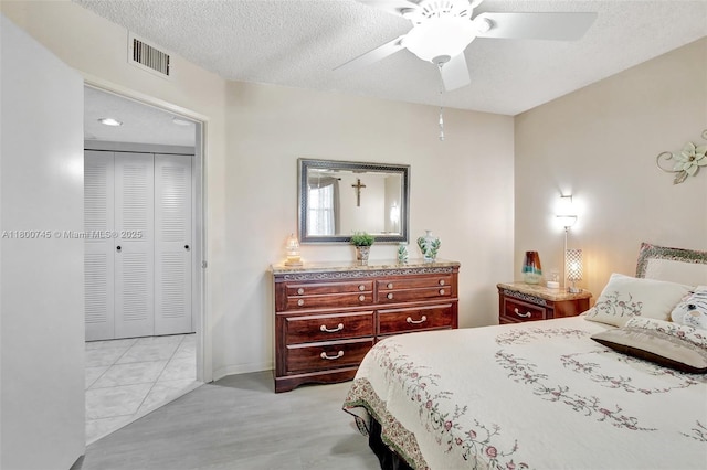 bedroom featuring a textured ceiling, a ceiling fan, and baseboards