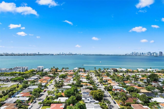 aerial view of residential area featuring a view of skyline and a large body of water