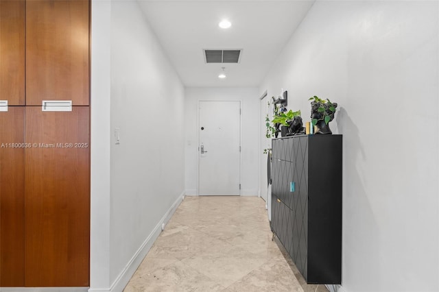 hallway featuring baseboards and recessed lighting