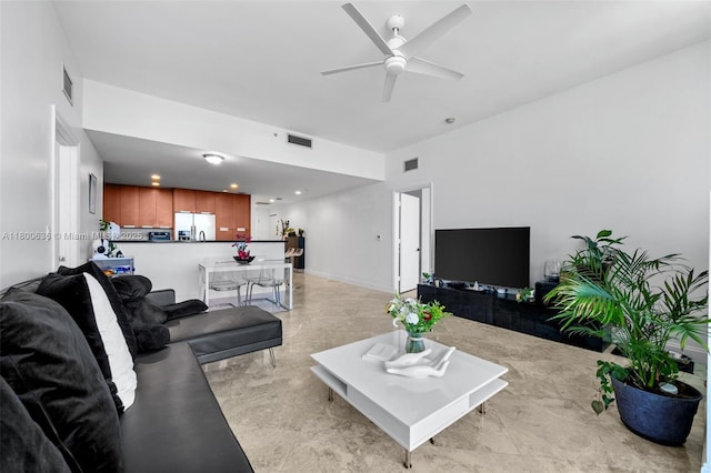 living area featuring a ceiling fan and recessed lighting