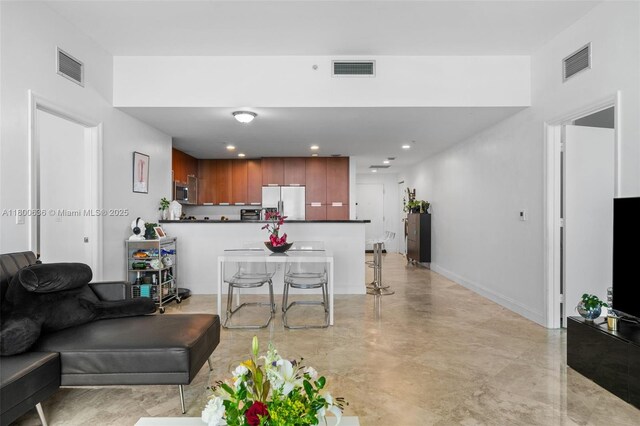 living area with recessed lighting and baseboards