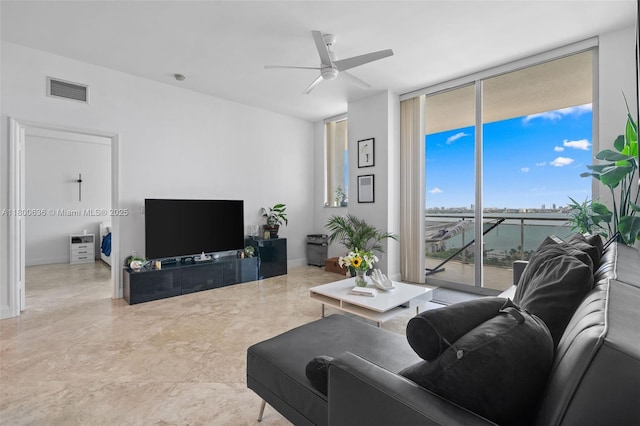 living room featuring a wall of windows and a ceiling fan