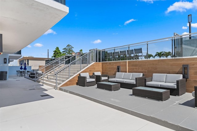 view of patio featuring outdoor lounge area and stairway
