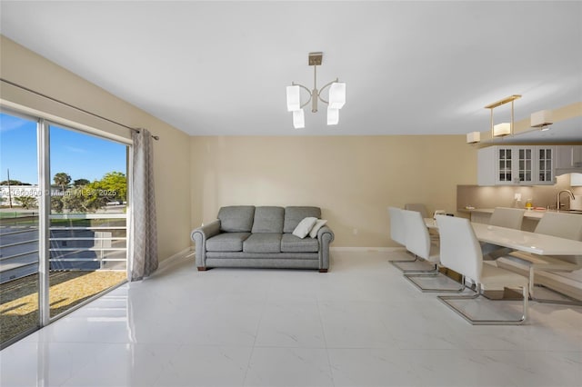 living area featuring baseboards and light marble finish flooring
