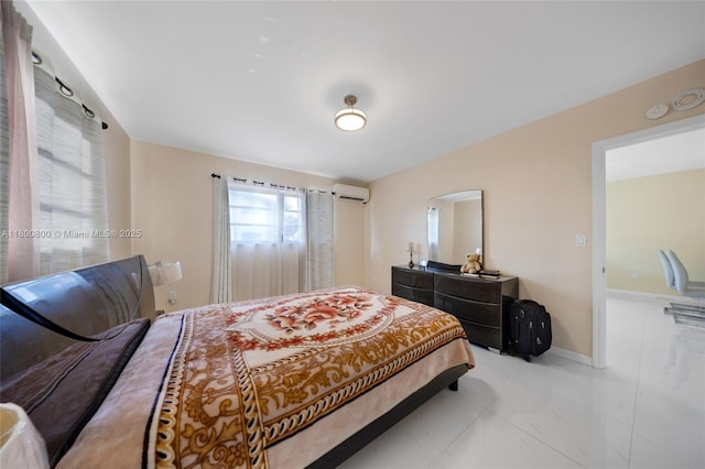 bedroom with a wall mounted air conditioner, arched walkways, and baseboards