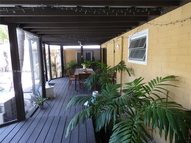wooden terrace featuring outdoor dining space