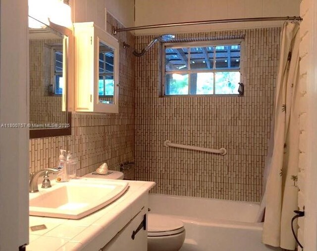 5858 SW 80th St, South Miami, FL 33143 - full bathroom with shower / bath combo, tile walls, vanity, toilet, and decorative backsplash