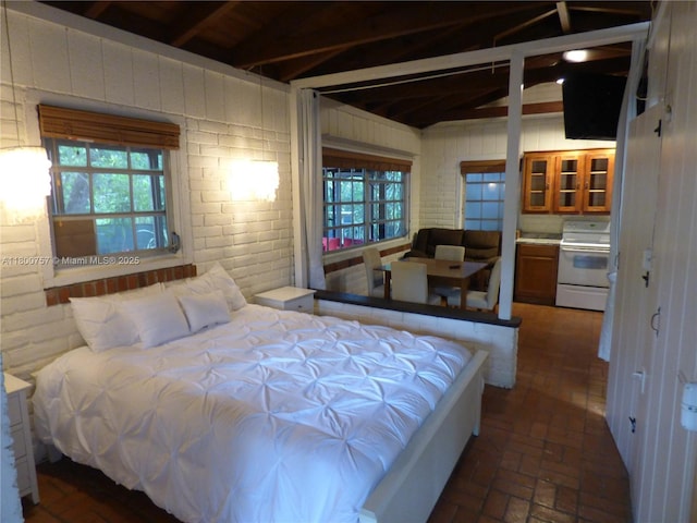 bedroom featuring brick floors and multiple windows