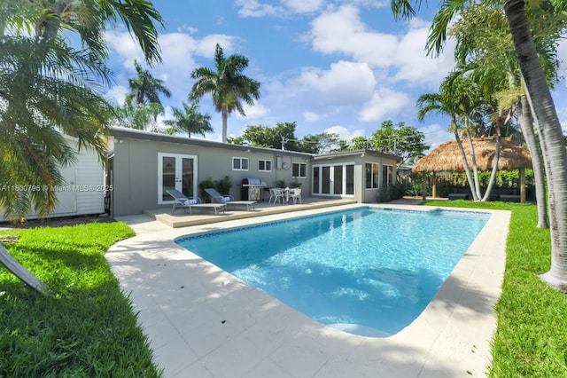 view of pool with french doors, a patio, and a gazebo
