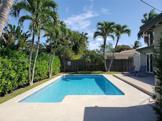 view of pool with a patio and a fenced backyard
