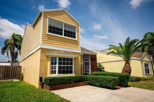 12840 SW 146th Ln, Miami, FL 33186 - traditional-style home with a patio, fence, stucco siding, and roof with shingles