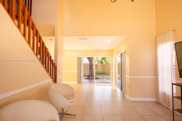 12840 SW 146th Ln, Miami, FL 33186 - foyer featuring a high ceiling, stairs, light tile patterned flooring, and baseboards