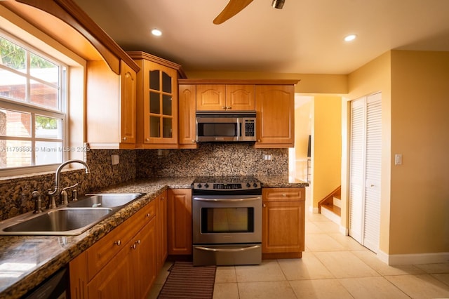 12840 SW 146th Ln, Miami, FL 33186 - kitchen with appliances with stainless steel finishes, a sink, backsplash, glass insert cabinets, and baseboards