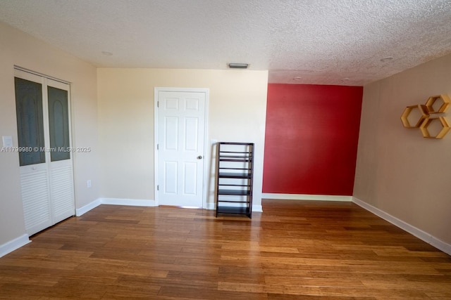 12840 SW 146th Ln, Miami, FL 33186 - empty room featuring wood finished floors, baseboards, and a textured ceiling