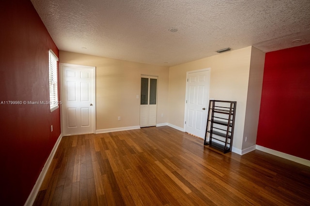 12840 SW 146th Ln, Miami, FL 33186 - unfurnished room with wood finished floors, a textured ceiling, and baseboards