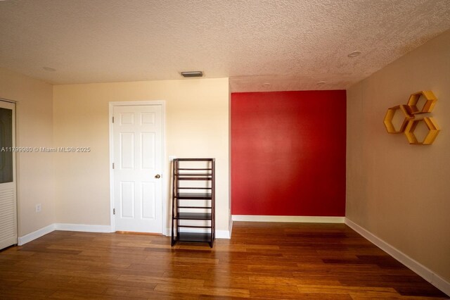 12840 SW 146th Ln, Miami, FL 33186 - spare room with wood finished floors, a textured ceiling, and baseboards