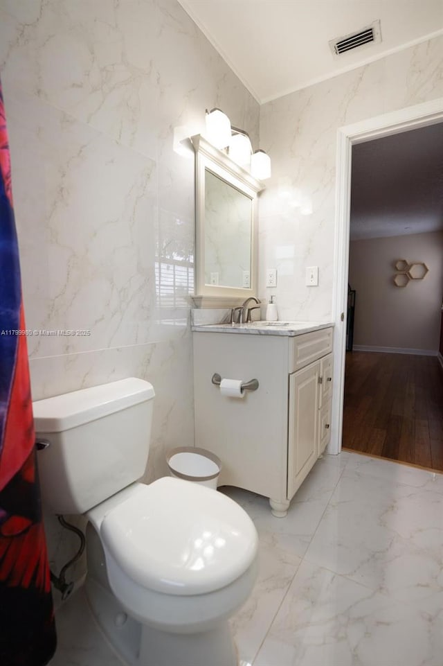 12840 SW 146th Ln, Miami, FL 33186 - bathroom featuring marble finish flooring, toilet, vanity, tile walls, and crown molding
