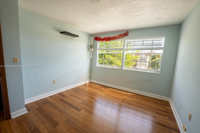 12840 SW 146th Ln, Miami, FL 33186 - unfurnished room with a textured ceiling, hardwood / wood-style floors, and baseboards