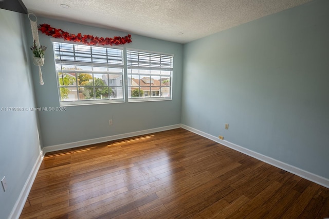 12840 SW 146th Ln, Miami, FL 33186 - spare room featuring wood finished floors, a textured ceiling, and baseboards