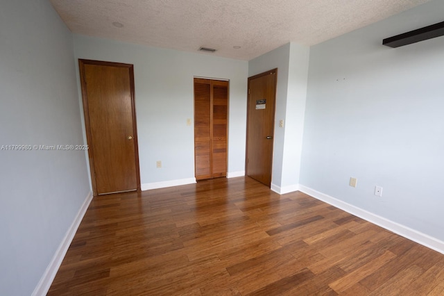 12840 SW 146th Ln, Miami, FL 33186 - spare room with wood finished floors, a textured ceiling, and baseboards