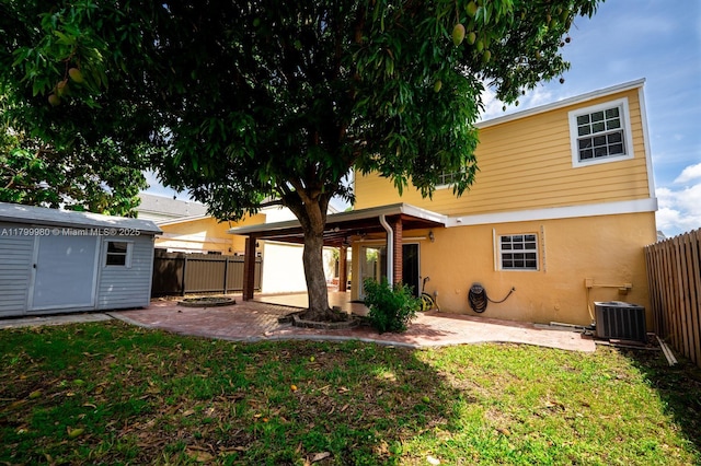 12840 SW 146th Ln, Miami, FL 33186 - rear view of house featuring a patio area, stucco siding, central AC unit, and an outdoor structure