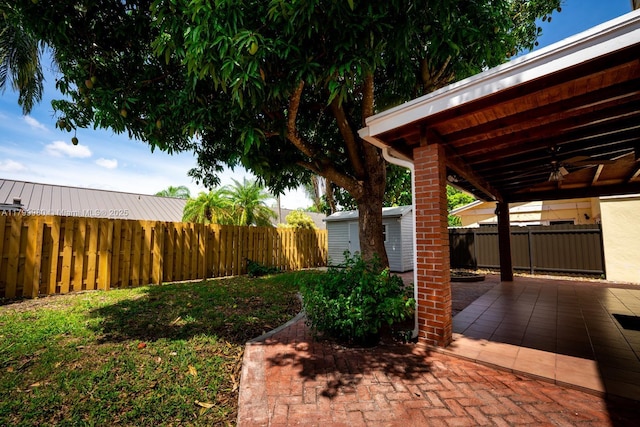 12840 SW 146th Ln, Miami, FL 33186 - view of yard featuring a ceiling fan, a patio, an outbuilding, and a storage unit
