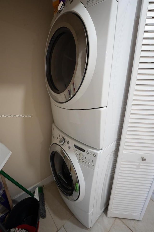 12840 SW 146th Ln, Miami, FL 33186 - washroom with estacked washer and dryer and light tile patterned flooring
