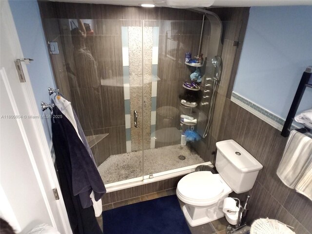 bathroom featuring a shower stall and toilet