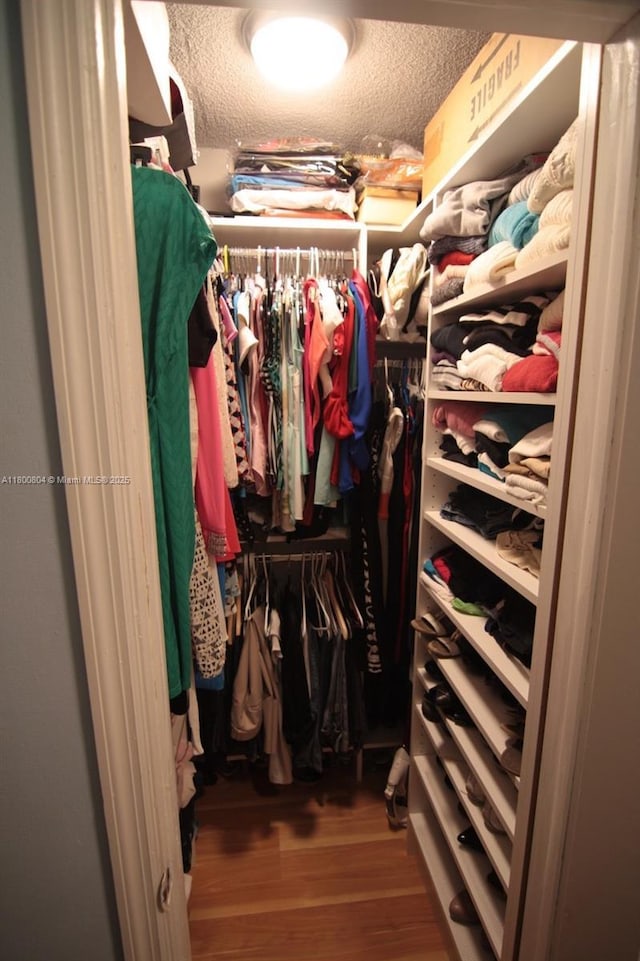 spacious closet with wood finished floors