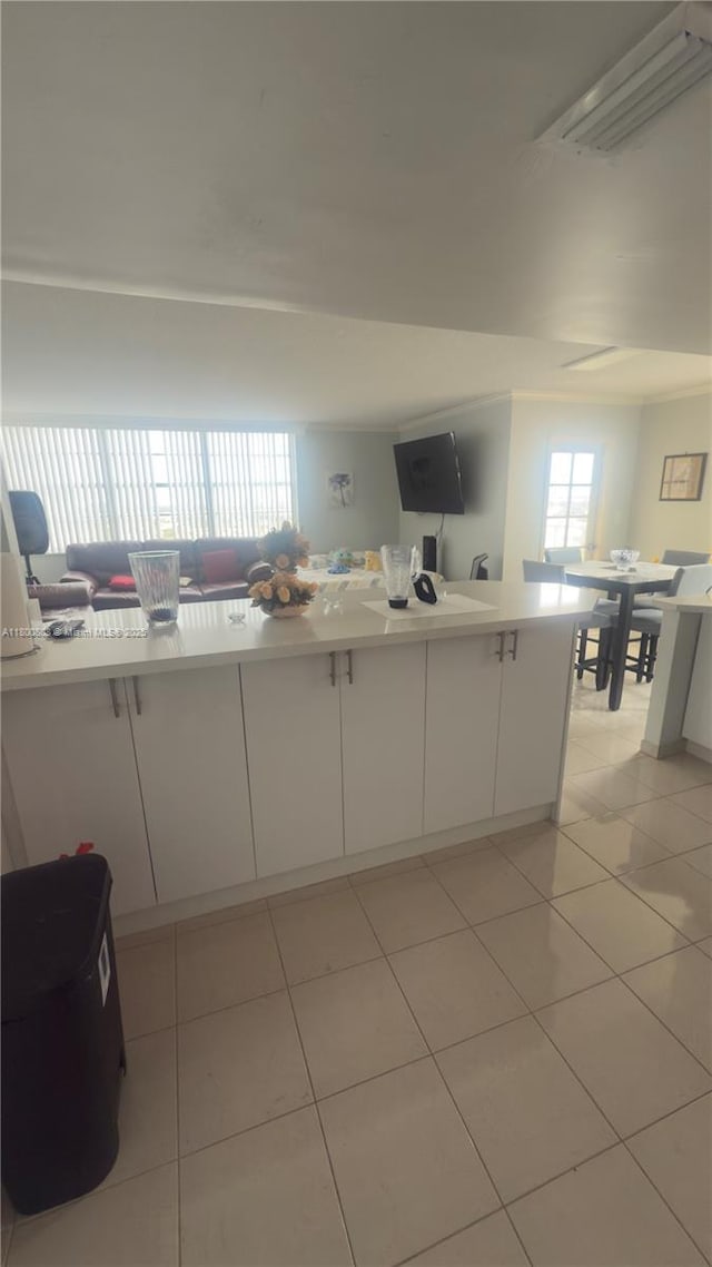 1351 NE Miami Gardens Dr Unit 1225E, Miami, FL 33179 - kitchen with white cabinetry, light tile patterned flooring, and light countertops