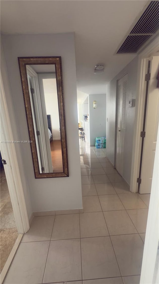 1351 NE Miami Gardens Dr Unit 1225E, Miami, FL 33179 - hallway with light tile patterned flooring and baseboards