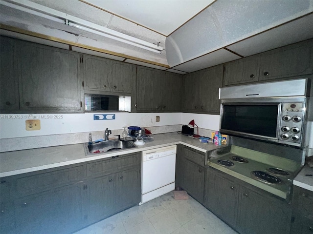 1470 NE 125th Ter Unit 810, North Miami, FL 33161 - kitchen featuring a sink, white dishwasher, light countertops, and cooktop
