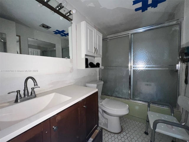 1470 NE 125th Ter Unit 810, North Miami, FL 33161 - bathroom with toilet, combined bath / shower with glass door, vanity, and tile patterned flooring