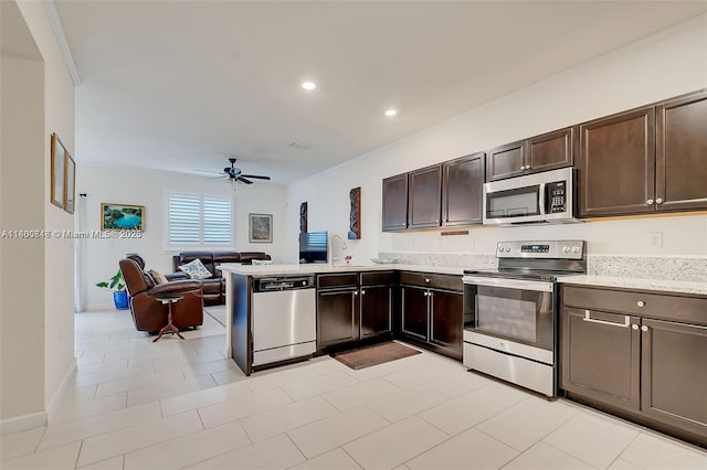 15073 SW 119th Ln, Miami, FL 33196 - kitchen with stainless steel appliances, ceiling fan, open floor plan, dark brown cabinets, and a sink
