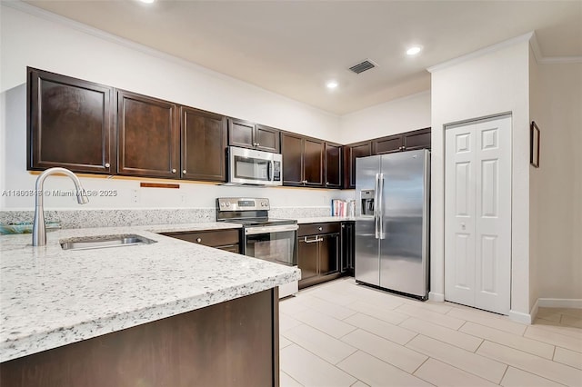 15073 SW 119th Ln, Miami, FL 33196 - kitchen featuring appliances with stainless steel finishes, a sink, dark brown cabinetry, ornamental molding, and light stone counters