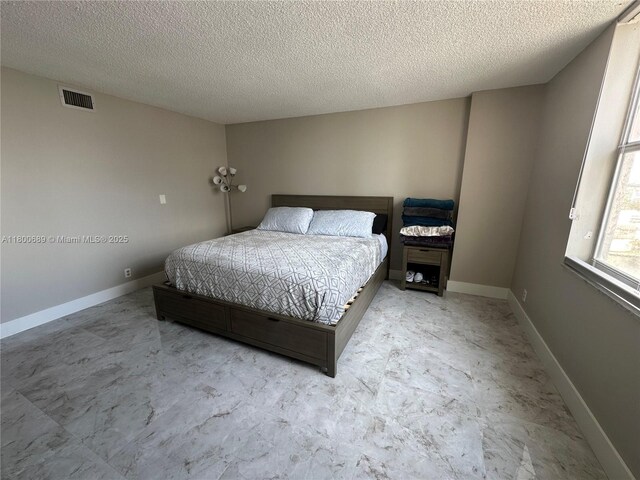 1865 S Ocean Dr Unit 17C, Hallandale Beach, FL 33009 - bedroom featuring a textured ceiling and baseboards
