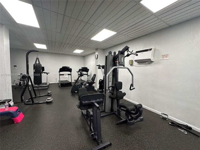 1865 S Ocean Dr Unit 17C, Hallandale Beach, FL 33009 - exercise room with baseboards, a textured wall, and a drop ceiling