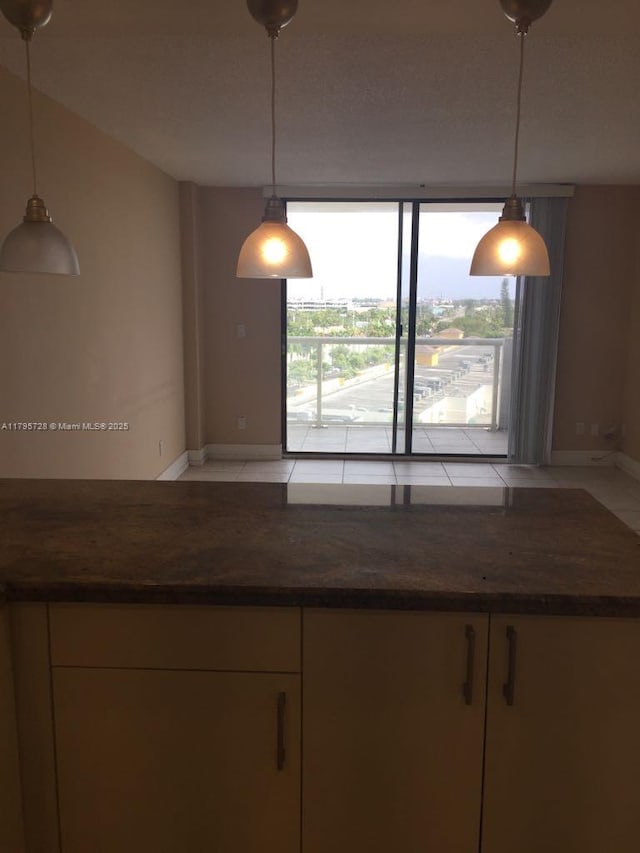 13499 Biscayne Blvd Unit 713, North Miami, FL 33181 - kitchen featuring dark countertops, baseboards, decorative light fixtures, and floor to ceiling windows