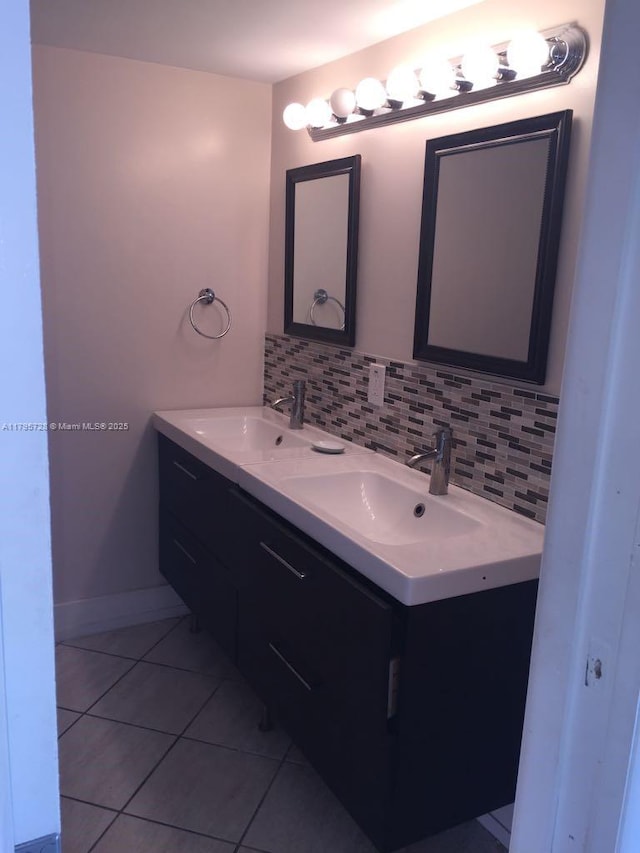 13499 Biscayne Blvd Unit 713, North Miami, FL 33181 - bathroom with backsplash, tile patterned floors, double vanity, and baseboards