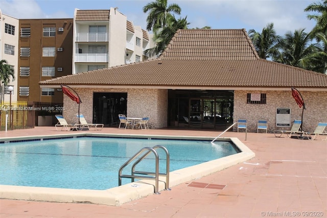 community pool with a patio area