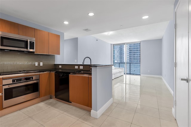 1060 Brickell Ave Unit 1811, Miami, FL 33131 - kitchen featuring black appliances, a sink, a peninsula, open floor plan, and tasteful backsplash