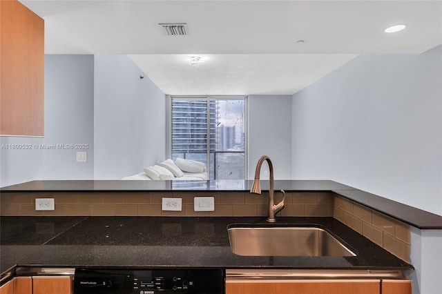 1060 Brickell Ave Unit 1811, Miami, FL 33131 - kitchen with a sink, dishwashing machine, dark stone counters, and open floor plan