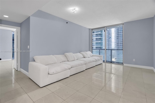 1060 Brickell Ave Unit 1811, Miami, FL 33131 - living room featuring baseboards, light tile patterned flooring, and floor to ceiling windows