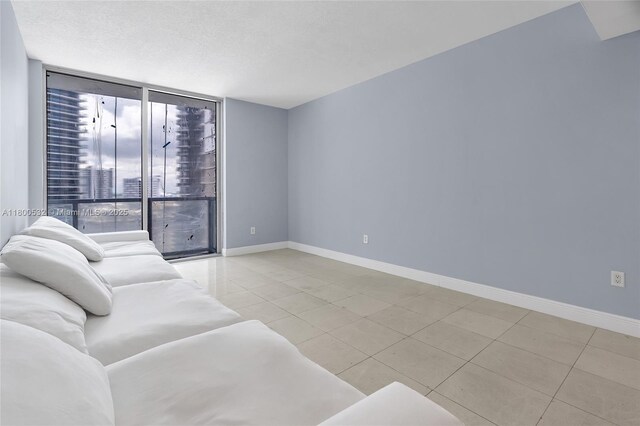 1060 Brickell Ave Unit 1811, Miami, FL 33131 - living area featuring a wall of windows, light tile patterned floors, and baseboards