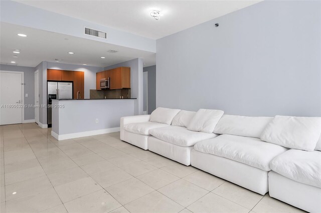 1060 Brickell Ave Unit 1811, Miami, FL 33131 - living area with light tile patterned flooring, recessed lighting, and baseboards
